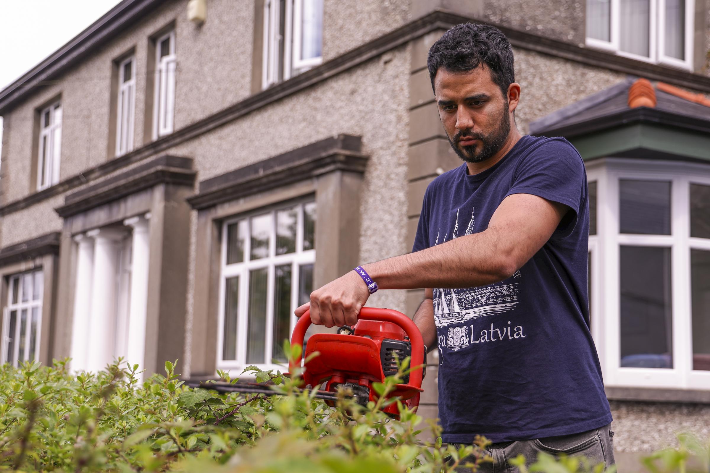 Martin Torres, Mexico, trimming the hedge.