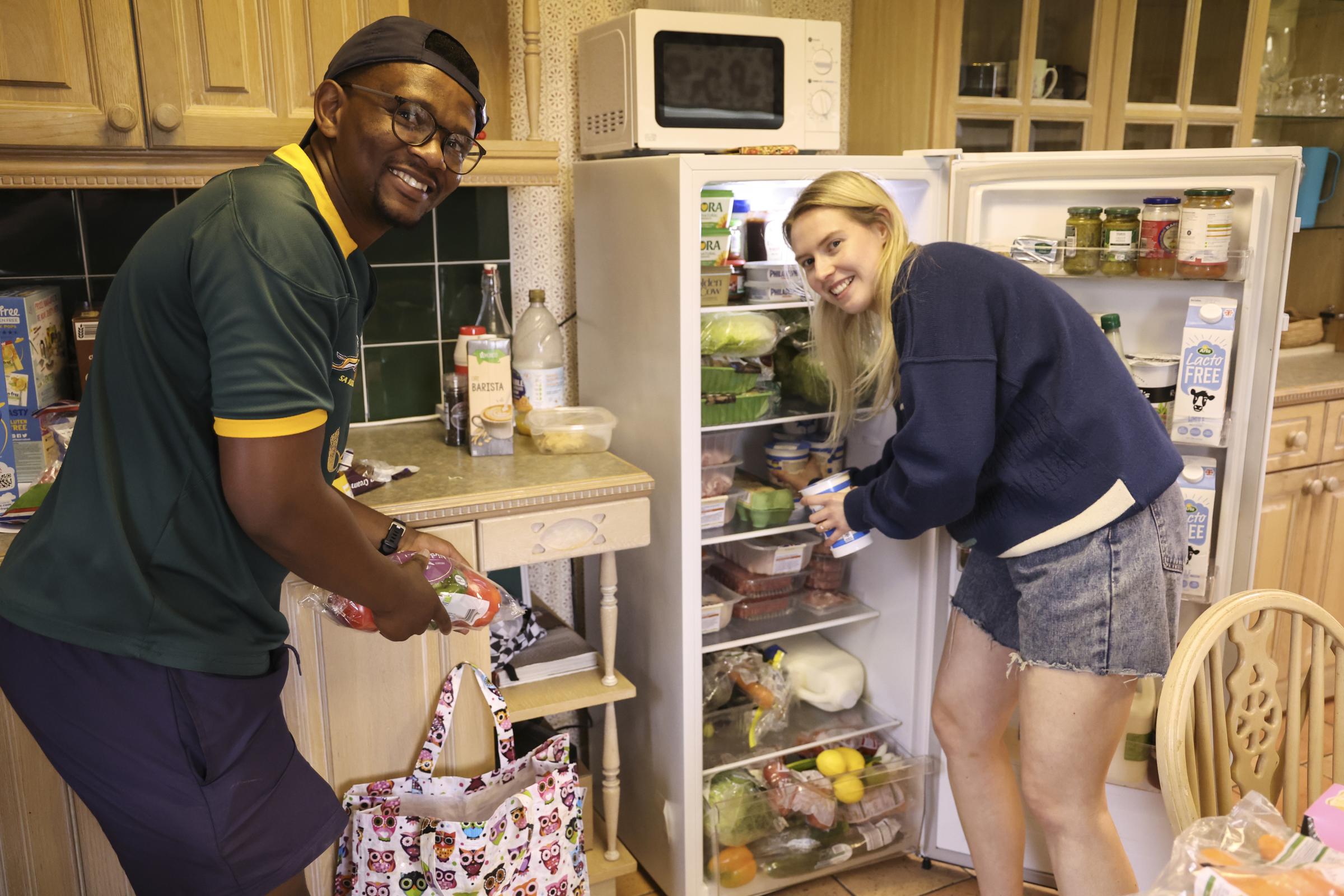 Musa Ncane, South Africia and Roberta Burton, Aughnacloy, stocking up the fridge with food.